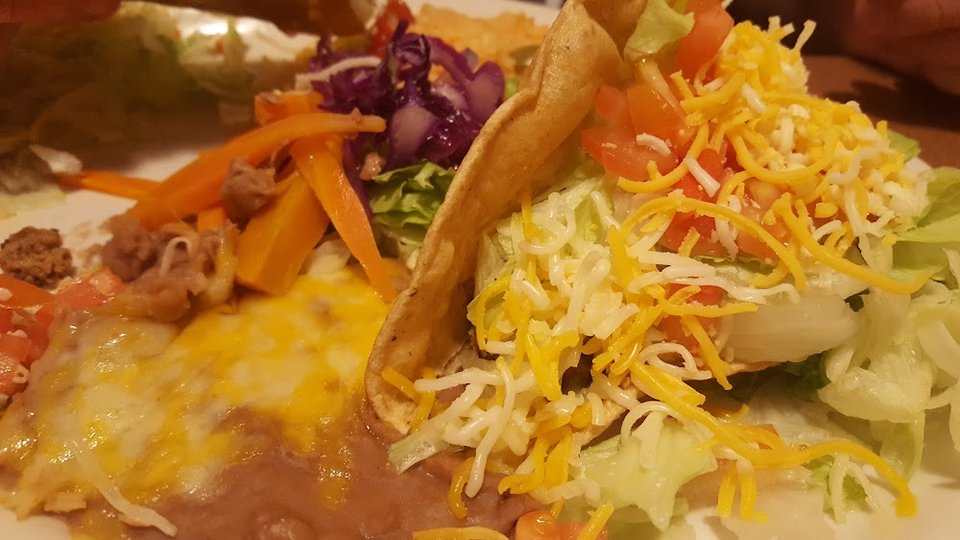 Mexican menu featuring tacos and burritos.